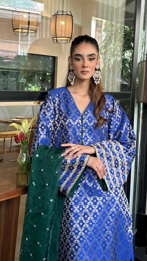 Blue Brocade Wedding Suit by Pyoor paired with embroidered contrast green dupatta.