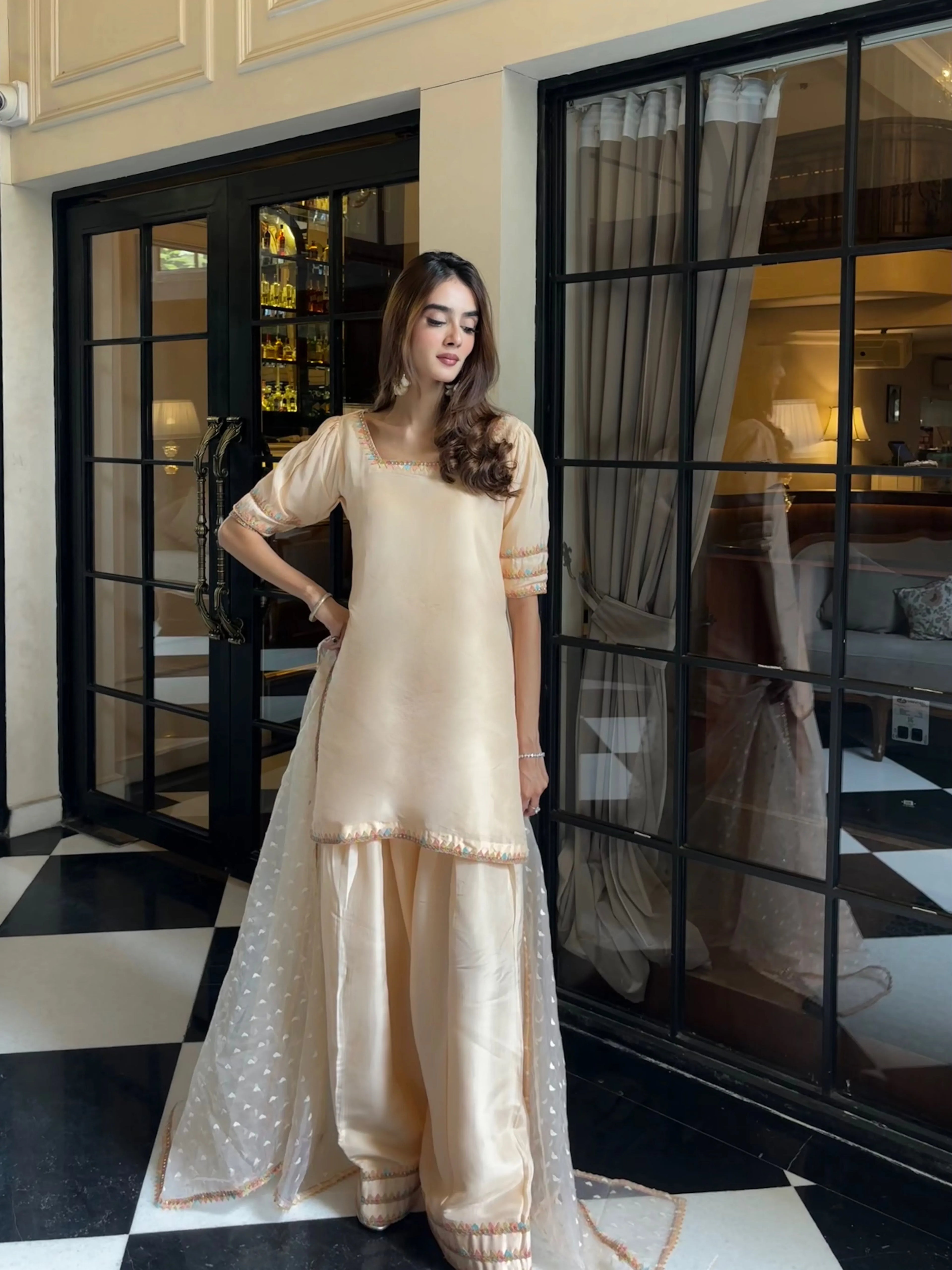 Nazm Peach Silk Farshi Set by Pyoor with elegant lace accents and festive embroidery